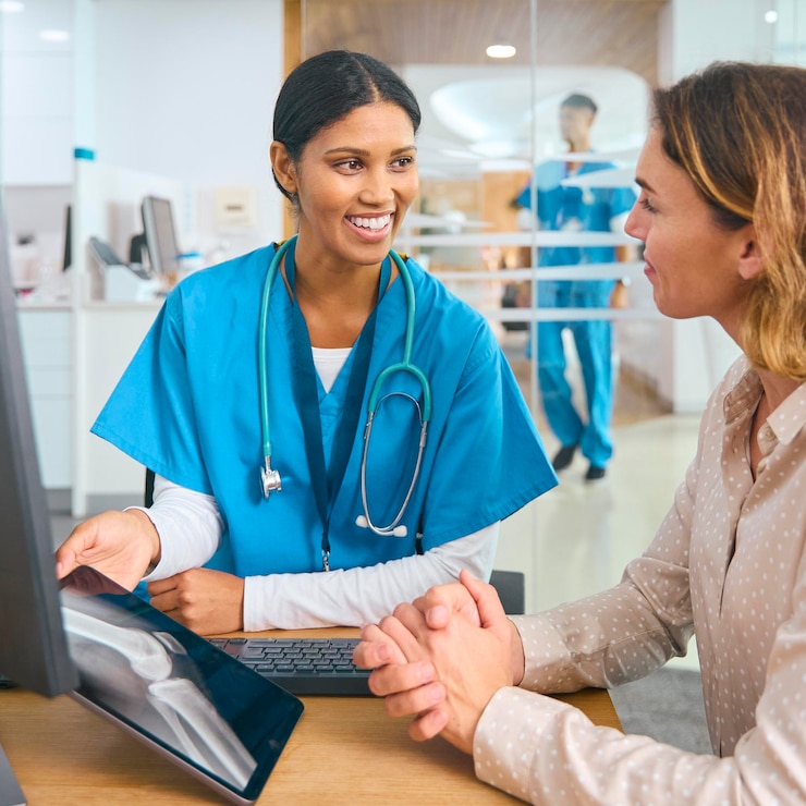 female-doctor-wearing-scrubs-hospital-appointment-with-woman-patient-looking-digital-tablet_1074916-14431
